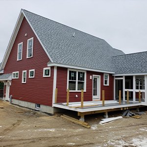 Dark red home with dark gray roofing